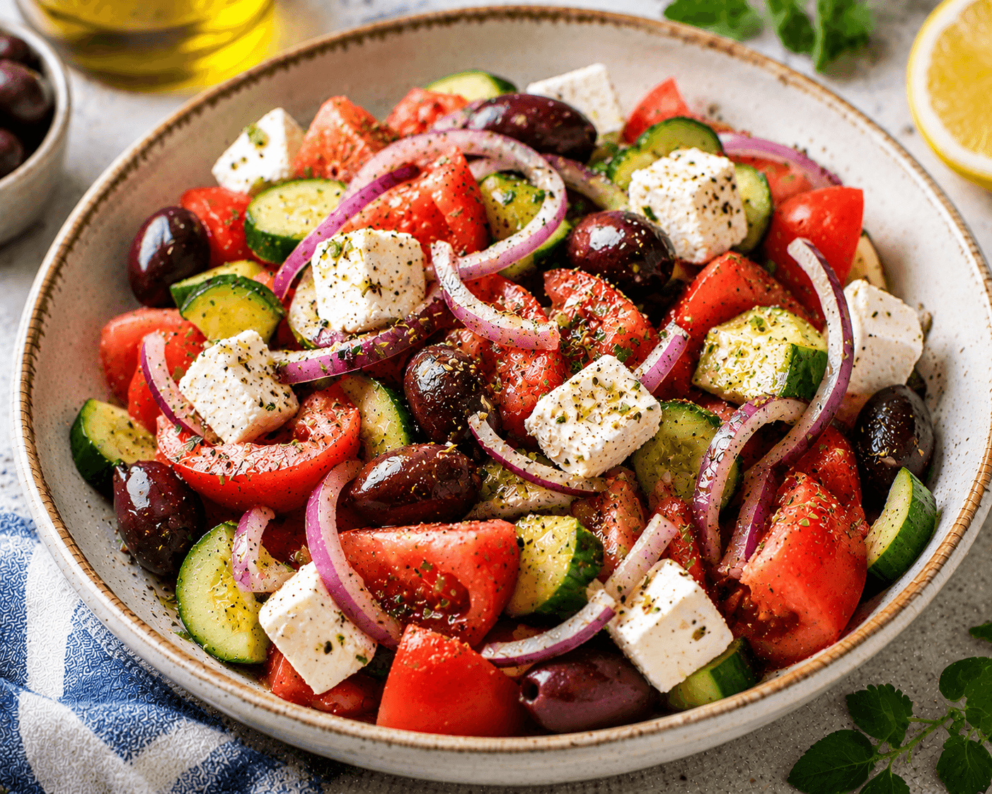 Traditional Greek salad served with tomatoes, cucumber, feta cheese, olives, red onion and oregano.
