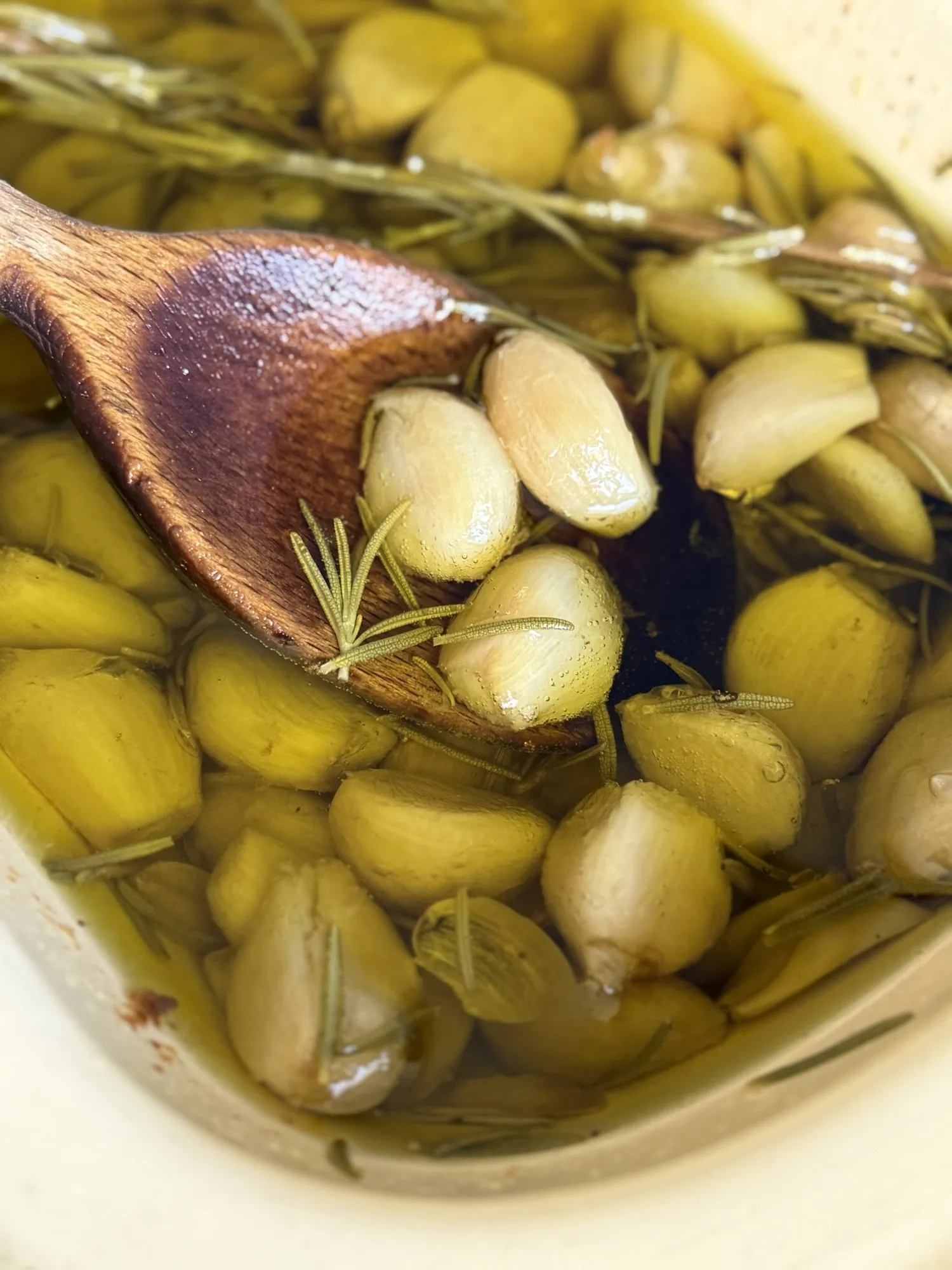 Fresh garlic cloves and rosemary gently infused in olive oil