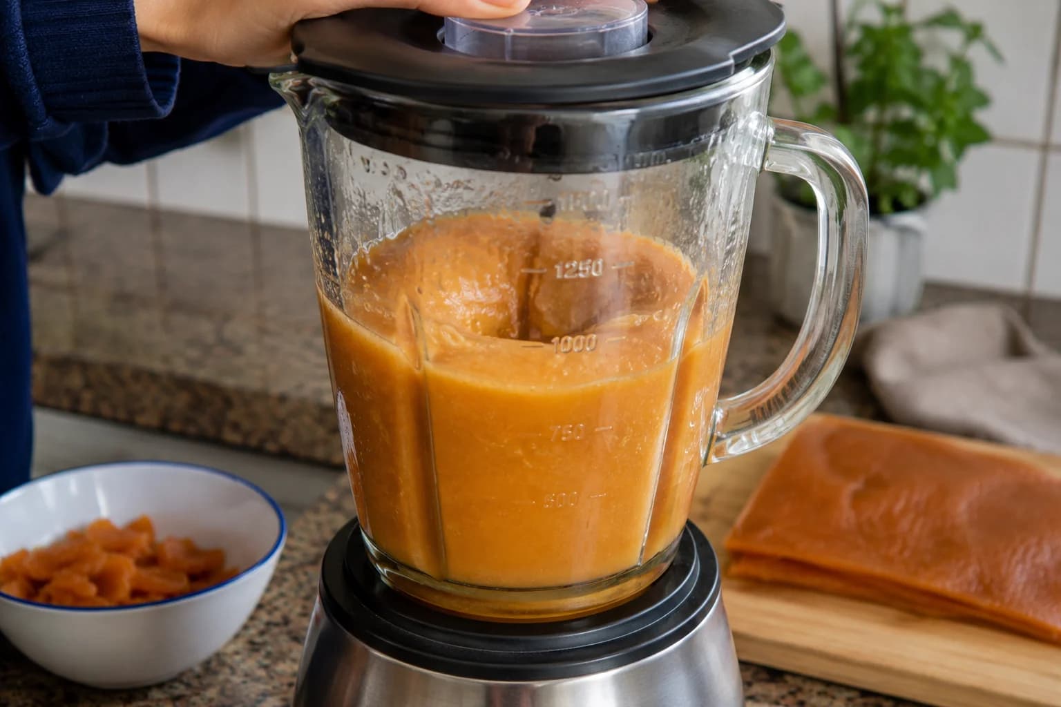Softened Qamar al-Din apricot mixture being blended into a smooth drink.