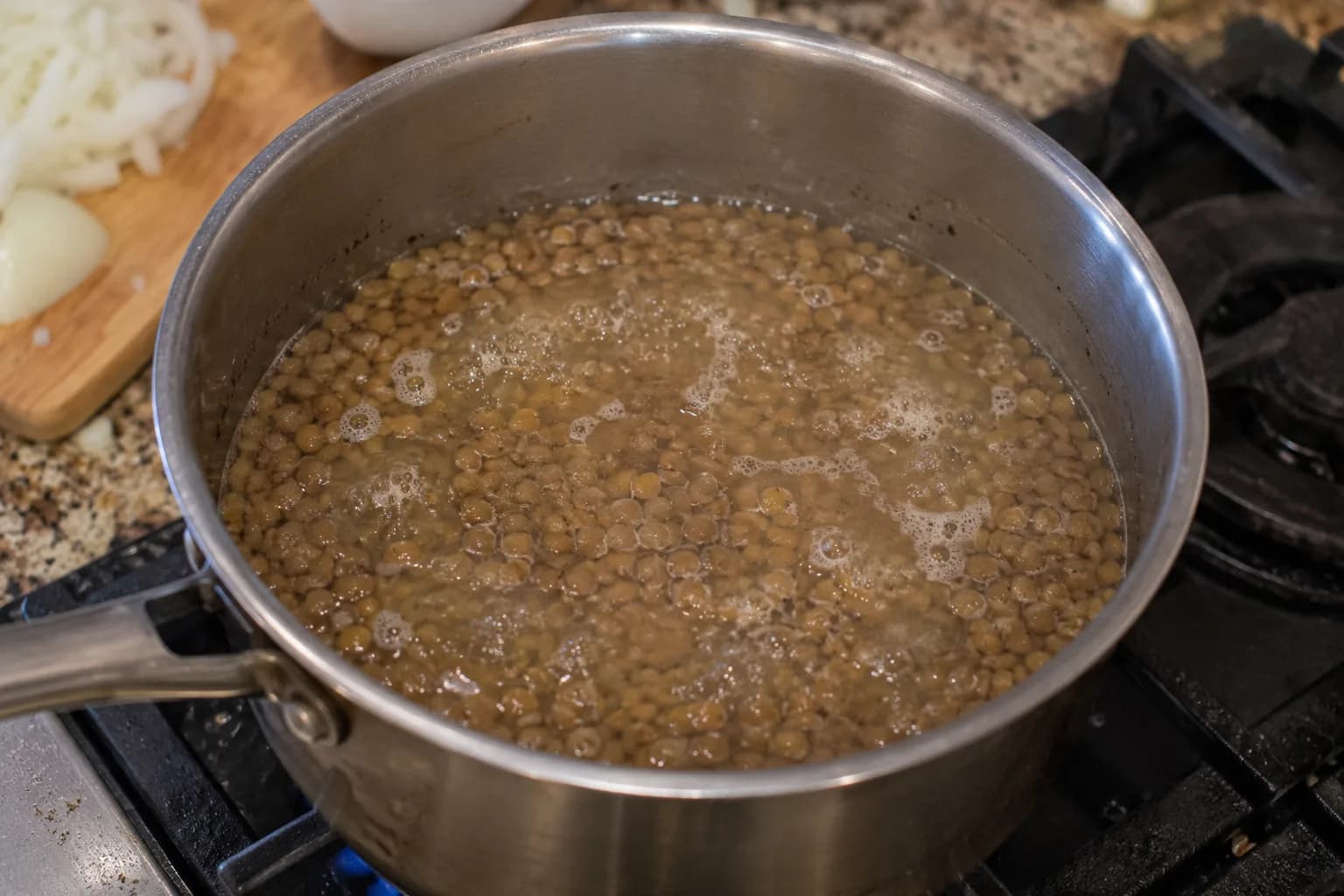 Brown lentils simmering in water until nearly tender for Lebanese Mujadara.