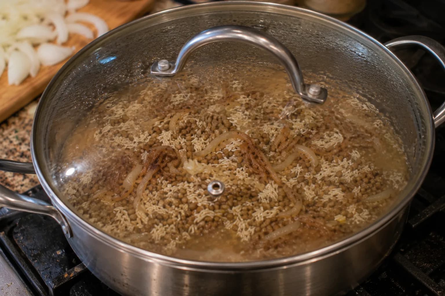 Covered pot of rice and lentils simmering gently in vegetable broth for Lebanese Mujadara.