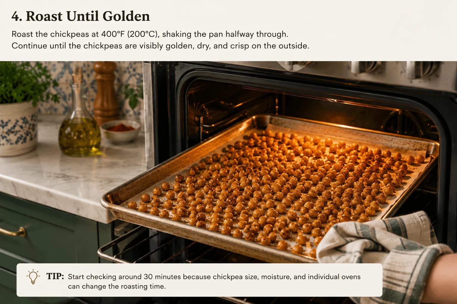 Golden seasoned chickpeas roasting on a baking sheet in a stylish Mediterranean kitchen.